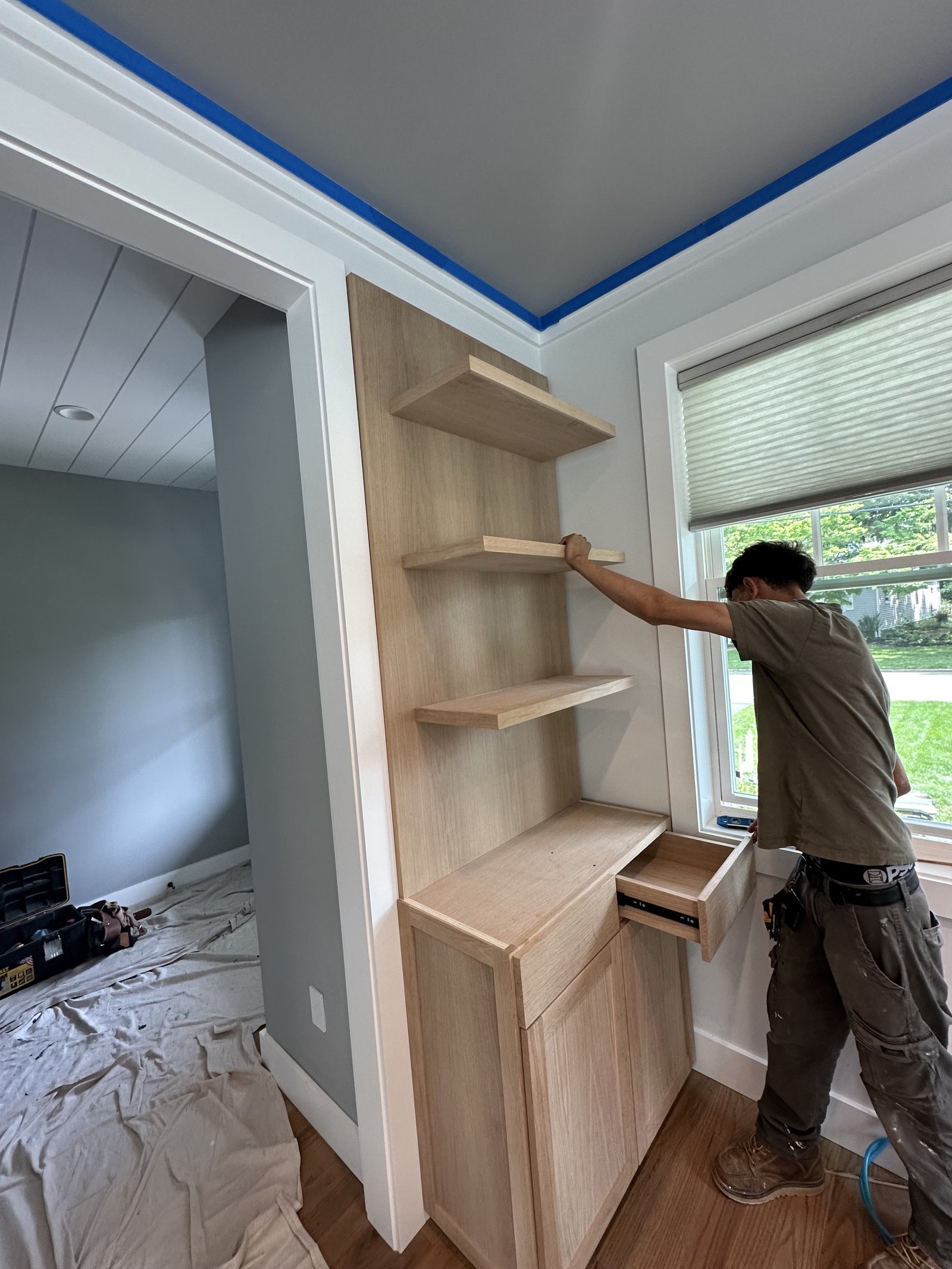 Floating shelves + built‑in cabinet